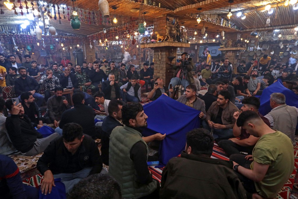 Customers are pictured at Nabaz Chawshin's cafe in Erbil, March 26, 2023. (Photo: Safin Hamed/AFP)